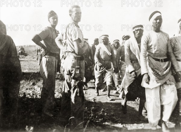 Escorting Arab detainees, Palestine. British soldiers escorts a column of Palestinian Arab men along a rural road, after detaining them at 'Windy Corner'. During the period of the Great Uprising (1936-39), an additional 20,000 British troops were deployed to Palestine in an attempt to clamp down on Arab dissidence. British Mandate of Palestine (Middle East), 1938., Middle East, Asia.
