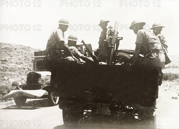 British soldiers with light mortar, Palestine. British soldiers and light mortar are transported to Haifa in the back of an open truck. During the period of the Great Uprising (1936-39), an additional 20,000 British troops were deployed to Palestine in an attempt to clamp down on Arab dissidence. Near Haifa, British Mandate of Palestine (Israel), circa 1938., Haifa, Israel, Middle East, Asia.