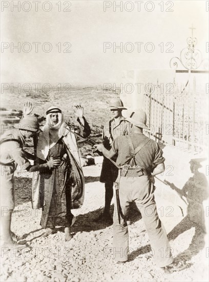 British soldiers searching a Palestinian Arab. Two British soldiers perform a body search on a Palestinian Arab suspect, while a third points a bayonetted rifle at his head. During the period of the Great Uprising (1936-39), an additional 20,000 British troops were deployed to Palestine in an attempt to clamp down on Arab dissidence. British Mandate of Palestine (Middle East), circa 1938., Middle East, Asia.