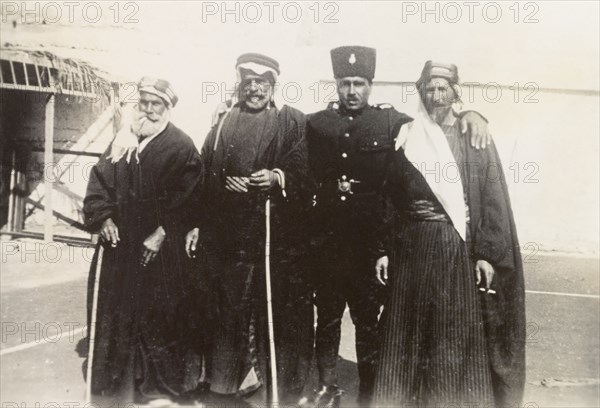 Palestinian police officer with 'mukhtars'. An officer of the Palestine Police Force poses for a group portrait with three Arab 'mukhtars' (village leaders). British Mandate of Palestine (Middle East), circa 1938., Middle East, Asia.