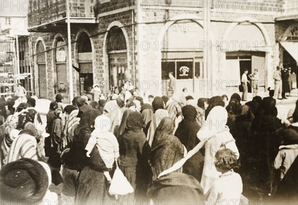 Funeral procession in Tiberias. Crowds of people take to the streets to join a funeral procession. Tiberias, British Mandate of Palestine (Israel), circa 1938. Tiberias, North (Israel), Israel, Middle East, Asia.