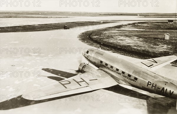 Dutch aeroplane on Lydda runway. A KLM Royal Dutch Airlines aeroplane, the PH-ALV 'Valk', sits on the runway at Lydda Airport. Lydda, British Mandate of Palestine (Lod, Israel), circa 1938. Lod, Central (Israel), Israel, Middle East, Asia.
