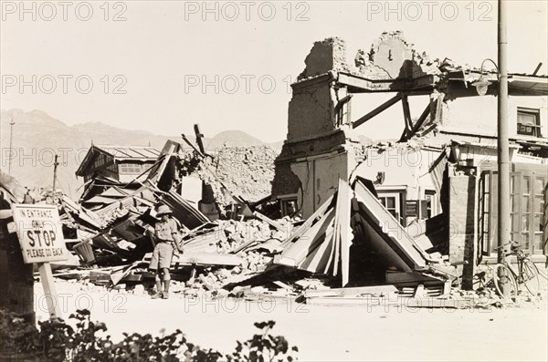 Earthquake damage in Quetta, 1935. A European man stands in the debris of a ruined building, reduced to rubble by an earthquake measuring 7.7 on the Richter scale. The earthquake hit Balochistan on 31 May 1935 and is thought to have killed between 30,000 to 60,000 people. Quetta, Balochistan, India (Pakistan), 1935. Quetta, Balochistan, Pakistan, Southern Asia, Asia.