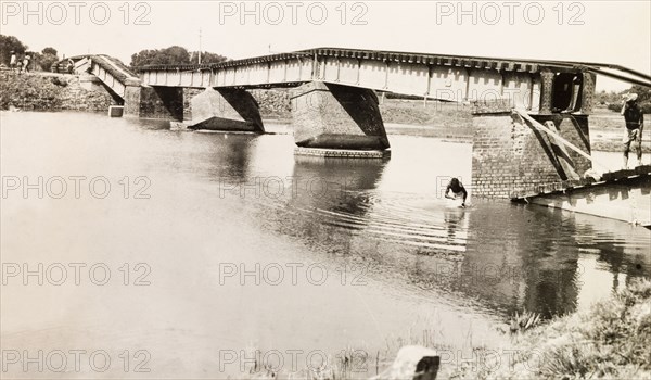 A bridge damaged by earthquake, Bihar. A collapsed railway bridge spans a river, damaged by an earthquake that struck near the India-Nepal border on 15 January 1934, killing approximately 10,500 people. Bihar, India, 1934., Bihar, India, Southern Asia, Asia.