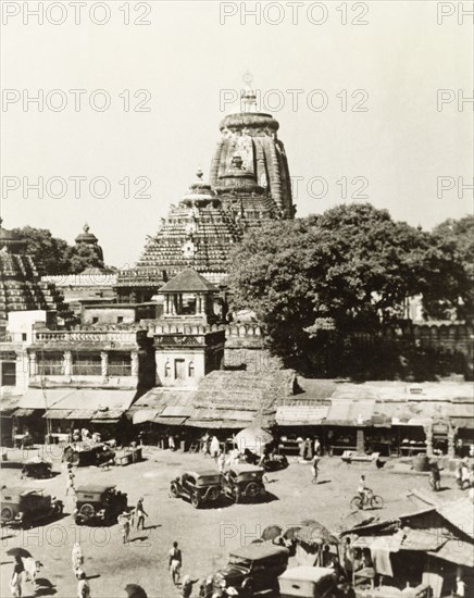 Jagannath Temple in Puri. View overlooking a town square in Puri, towards the Jagannath Temple, a Hindu temple dedicated to Lord Jagannath (a deity form of Krishna). An original caption comments that this square is the site of Puri's annual Rath Yatra festival. Puri, India, October 1934. Puri, Orissa, India, Southern Asia, Asia.