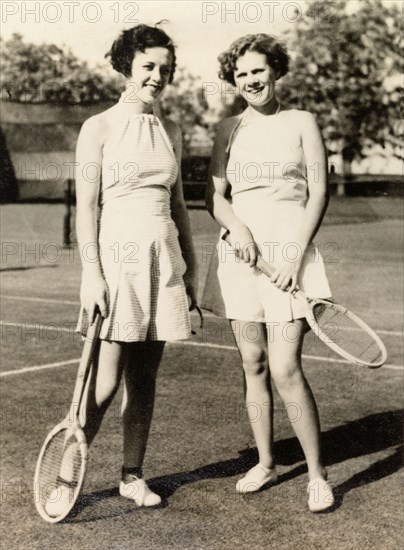 Playing tennis, Calcutta, 1935. Two American women, Mildred and Helen, pose with their racquets on a tennis court, during a "tennis weekend" with British friends at a jute mill near Calcutta. Calcutta (Kolkata), India, April 1935. Kolkata, West Bengal, India, Southern Asia, Asia.