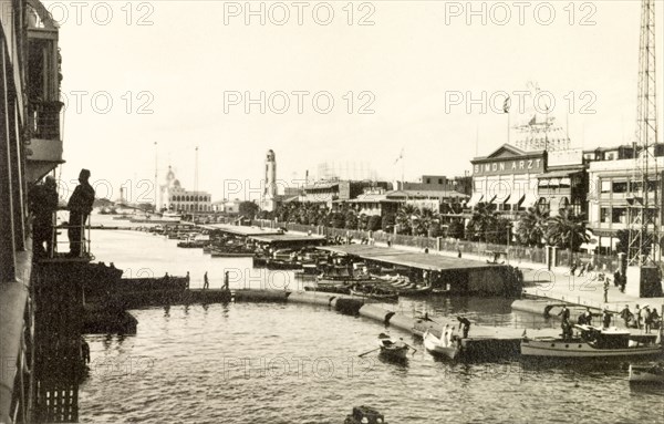 Port Said quayside, 1938. View of the quayside at Port Said. The department store 'Simon Artz' can be seen facing the waterfront on the right, a popular shop with European travellers bound for India who would stop to purchase their solatopi hats. Port Said, Egypt, November 1938. Port Said, Port Said, Egypt, Northern Africa, Africa.