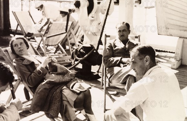 Relaxing on the deck of the Otranto. Passengers relax in deckchairs on the deck of the 'Otranto', a passenger liner belonging to the Orient Line. The ship was travelling from Colombo in Ceylon (Sri Lanka) to Plymouth in England. Indian Ocean, February 1939., Indian Ocean, Africa.