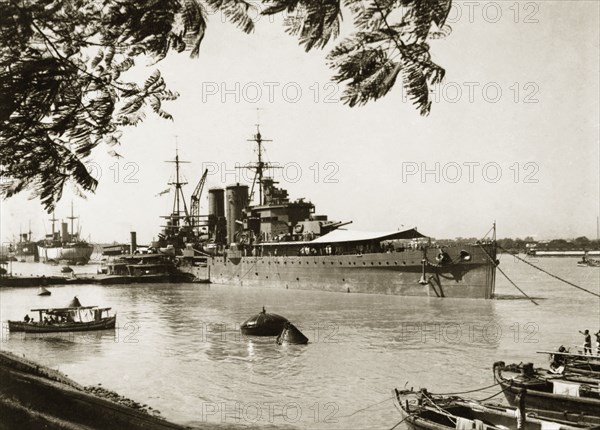 HMS Exeter at Garden Reach shipyard. View of British Royal Navy cruiser HMS Exeter, moored at Garden Reach shipyard in Calcutta enroute to Singapore. Calcutta (Kolkata), India, November 1940. Kolkata, West Bengal, India, Southern Asia, Asia.