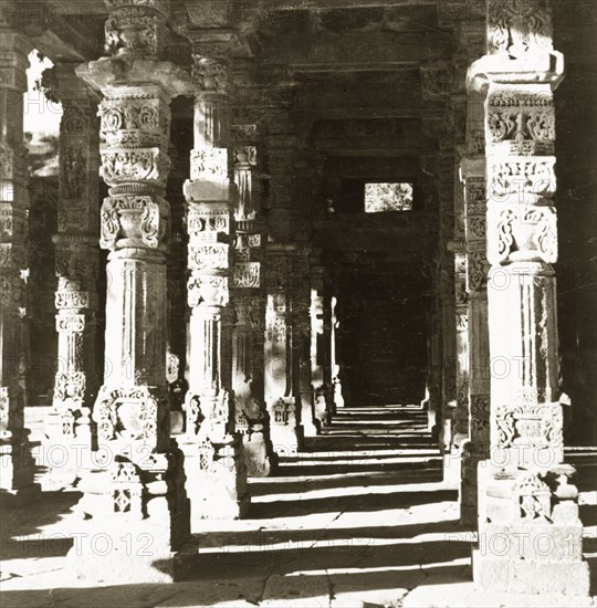 Carved pillars at the Quwwat-ul-Islam Mosque. Intricately carved stone pillars line a passageway at the Quwwat-ul-Islam Mosque. Delhi, India, 1941. Delhi, Delhi, India, Southern Asia, Asia.