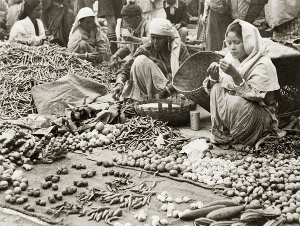 Fruit and vegetable stall at Darjeeling market. Two women sell various fruits, vegetables and spices, including chilli peppers and root ginger, on a stall at Darjeeling market. Darjeeling, India, 1942. Darjeeling, West Bengal, India, Southern Asia, Asia.