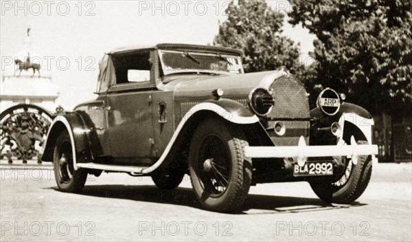 A Hotchkiss 1928, in a rich red'. A 1928 Hotchkiss car, parked outside the gates of the Victoria Memorial. The vehicle belonged to British businessman James Murray who comments in an original caption: "A real gem and one of my favourite cars". Calcutta (Kolkata), India, 1943. Kolkata, West Bengal, India, Southern Asia, Asia.