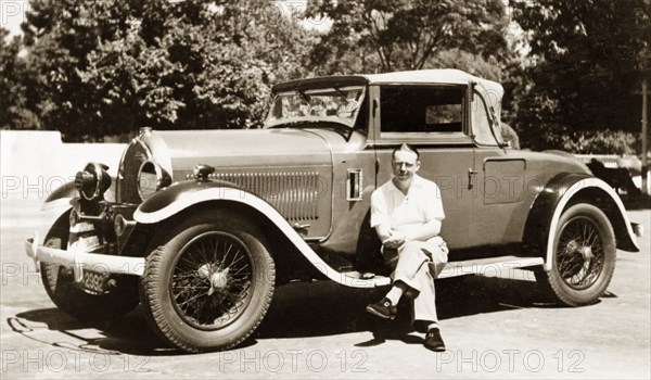 A 1928 Hotchkiss car. A European man poses beside a 1928 Hotchkiss car. The vehicle belonged to British businessman James Murray who comments in an original caption: "A real gem and one of my favourite cars". Calcutta (Kolkata), India, 1943. Kolkata, West Bengal, India, Southern Asia, Asia.