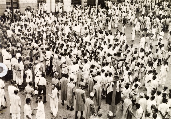 Policing the riots in Calcutta, 1946. Indian police form a barricade with lathis (bamboo sticks) to control crowds of Indian protesters on Old Court House Street. The photographer refers to the event as a "Communist demo", but it could be any one of a number of uprisings that plagued Calcutta in 1946. Two occasions that seem to fit are an attempt by student demonstrators to enter Dalhousie Square on 11 February, or the August riots relating to Direct Action Day. Calcutta (Kolkata), India, 1946. Kolkata, West Bengal, India, Southern Asia, Asia.