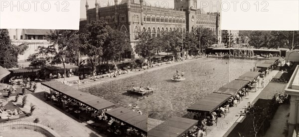 Calcutta Swimming Club, 1948. European bathers relax in and around the pool at Calcutta Swimming Club, in the shadow of the city's neo-Gothic High Court building. Calcutta (Kolkata), India, circa 1948. Kolkata, West Bengal, India, Southern Asia, Asia.