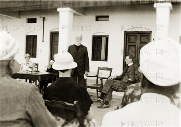 Opening of a new nurse's accommodation. Reverend George Sawday addresses a seated audience during the opening ceremony of new trainee nurse's accommodation at Holdsworth Memorial Hospital. The hospital was run by Methodist missionaries, who provided three year training courses for nurses. Mysore, India, January 1934. Mysore, Karnataka, India, Southern Asia, Asia.