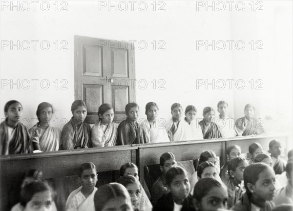 Students at girl's high school, Mysore. Rows of female Indian students sit on benches in a classroom at a girl's high school run by Methodist missionaries. Mysore, India, January 1934. Mysore, Karnataka, India, Southern Asia, Asia.
