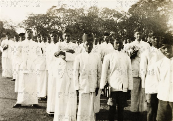 Students of a boy's mission school. Group portrait of uniformed male students of a Methodist mission college, some of whom carry text books under their arm. Tumkur, Mysore State (Tumakuru, Karnataka), India, 1933., Karnataka, India, Southern Asia, Asia.