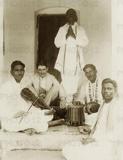 A Methodist evangelist band. Group portrait of a Methodist evangelist band, instruments in hand, posing with British missionary Reverend Norman Sargant. Tumkur, Mysore State (Tumakuru, Karnataka), India, 1933., Karnataka, India, Southern Asia, Asia.