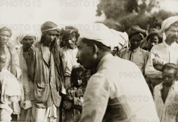 Evangelist preaching to villagers. Methodist evangelist T.B. William preaches to a crowd of Indian villagers. T.B. William was accompanying British missionary Reverend Norman Sargant, who travelled throughout Mysore State preaching to rural Christian communities. Mysore State (Karnataka), India, 1933., Karnataka, India, Southern Asia, Asia.