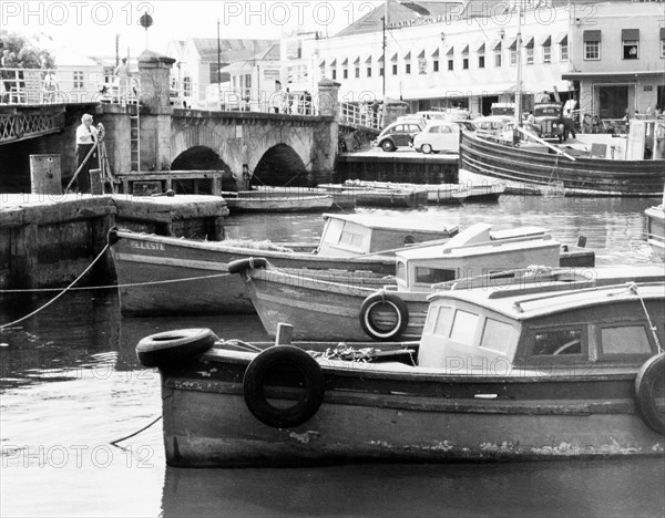 The Careenage in Bridgetown. A number of small motor boats are moored along the Careenage. Bridgetown, Barbados, 1965. Bridgetown, St Michael, Barbados, Caribbean, North America .