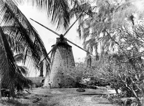 A sugar windmill, Barbados. A windmill without sails remains standing at a derelict sugar mill, one of many that once dotted the island. Barbados, 1965., Barbados, Caribbean, North America .