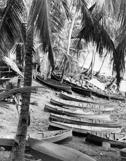 Fishing village near Roseau. Fishing canoes lie on a sandy beach at a village near Roseau. Dominica, 1965., Dominica, Caribbean, North America .