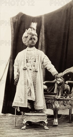 Maharajah of Patiala, 1903. Studio portrait of Bhupinder Singh (1891-1938), Maharajah of Patiala, posing by an ornate chair in ceremonial dress for Edward VII's Coronation Durbar. India, 1903. India, Southern Asia, Asia.