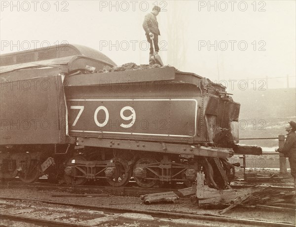 Train crash, Ontario. Railway workers inspect the damage caused to the rear of a steam locomotive after a train crash on the Hamilton railway line. Hamilton, Canada, February 1902. Hamilton, Ontario, Canada, North America, North America .
