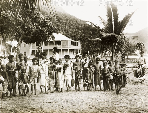 Ceylonian children. Portrait of a group of Ceylonian children, many of whom wear traditional 'longyis', posing in the grounds of a colonial-style house. Ceylon (Sri Lanka), November 1902. Colombo, West (Sri Lanka), Sri Lanka, Southern Asia, Asia.