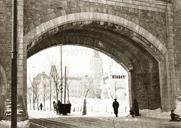 St Louis Gate, Quebec City. View of St Louis Gate on the fortified walls of Old Quebec City, where a horse-drawn sledge passes underneath on the snow covered ground. Quebec, Canada, February 1902. Quebec, Quebec, Canada, North America, North America .