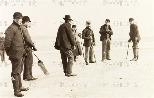 Ice cutters on Lake Ontario. A team of ice cutters, ice saws in hand, prepare to remove ice from Lake Ontario to store in a nearby icehouse. Hamilton, Canada, February 1902. Hamilton, Ontario, Canada, North America, North America .