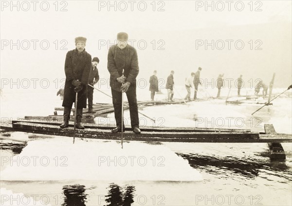 Ice cutters, Canada. A team of ice cutters stand on a pontoon bridge over Lake Ontario using ice saws to harvest ice. Hamilton, Canada, February 1902. Hamilton, Ontario, Canada, North America, North America .