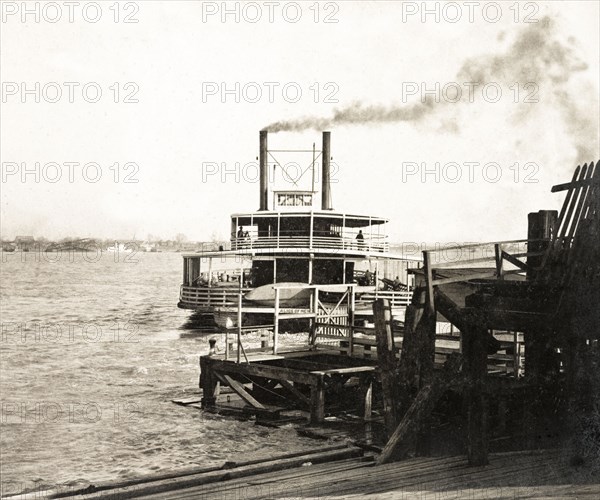 Cargo ship departing New Orleans. A cargo steamship departs a New Orleans wharf after delivering a shipment of oil cake, making the return journey up the Mississippi River. New Orleans, United States of America, March 1902. New Orleans, Louisiana, United States of America, North America, North America .