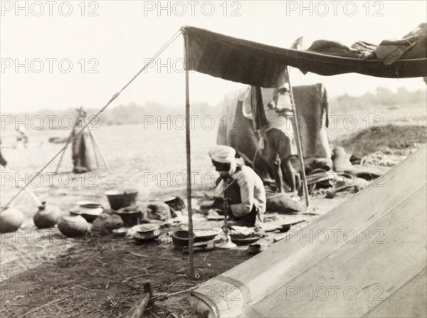 Mahouts camp at Coronation Durbar, 1903. Off-duty mahouts (elephant handlers) relax and cook outside a tent in their camp site at the Coronation Durbar. Delhi, India, circa 1 January 1903. Delhi, Delhi, India, Southern Asia, Asia.