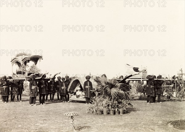Procession of palanquins at Coronation Durbar, 1903. Indian bearers carry a procession of ornate palanquins at the Coronation Durbar. Delhi, India, circa 1 January 1903. Delhi, Delhi, India, Southern Asia, Asia.