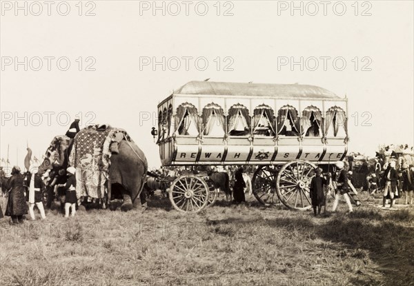 Rewah State's ceremonial carriage. A caparisoned elephant pulls Rewah State's large, ceremonial carriage at the Coronation Durbar. Delhi, India, circa 1 January 1903. Delhi, Delhi, India, Southern Asia, Asia.