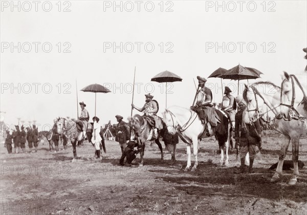 Chiefs of Bundi at the Coronation Durbar, 1903. Indian chiefs and dignitaries from Bundi State seated on horses under the shade of ceremonial umbrellas at the Coronation Durbar. Delhi, India, circa 1 January 1903. Delhi, Delhi, India, Southern Asia, Asia.