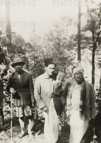 Evangelists trekking through mountain range. Methodist evangelists trek through the Baba Budan Giri mountain range near Pandaravalli. The group were travelling to a remote coffee estate to show a display of magic lantern slides to the plantation workers. Mysore State (Karnataka), India, 1937., Karnataka, India, Southern Asia, Asia.