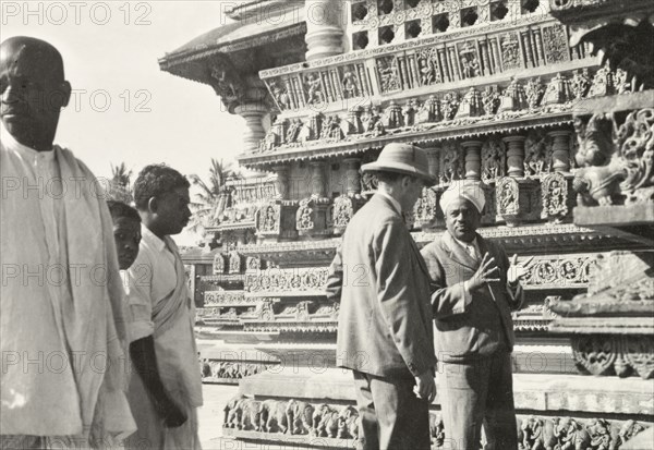 Sculptures on facade of Chennakesava Temple,. Two men, Mr F.C. Scott and Mr Sitaramayya, discuss the ornate sculptures that adorn the facade of Chennakesava Temple, a 12th century Vaishnava temple built by King Vishnuvardhana of the Hoysala dynasty. Belur, Mysore State (Karnataka), India, circa 1937., Karnataka, India, Southern Asia, Asia.