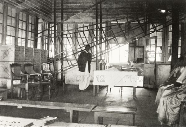 Tea factory laid out for a Christian ceremony. The interior of a factory on a tea estate prepared for a Christian church service. The room contains a table covered in a white cloth as an altar: two facing rows of chairs for the choir or distinguished guests: and a long bench to seat the congregation. Mysore State (Karnataka), India, circa 1937., Karnataka, India, Southern Asia, Asia.