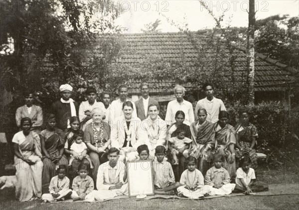 Reverend and congregation at Indian plantation. British missionary Reverend Norman Sargant (centre) poses for a group portrait with his Methodist congregation outside a colonial bungalow at a tea or coffee estate. Mysore State (Karnataka), India, 1938., Karnataka, India, Southern Asia, Asia.