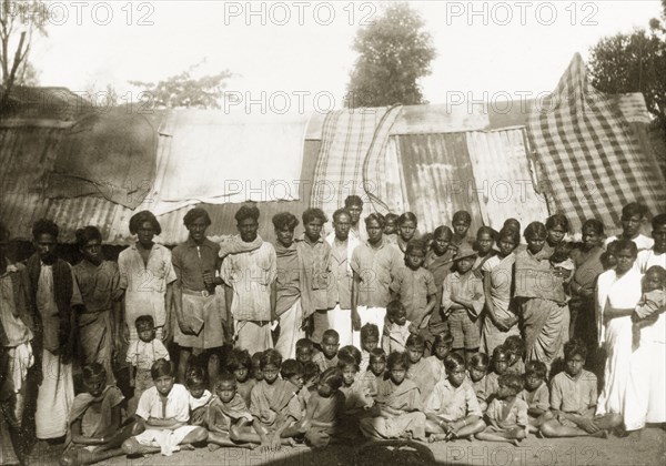 Tea estate workers and their families. A Christian congregation of plantation workers and their families gather for a group portrait outside accommodation at a tea estate. Mysore State (Karnataka), India, circa 1937., Karnataka, India, Southern Asia, Asia.
