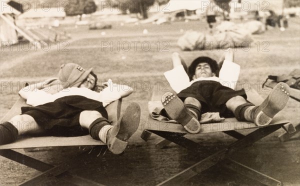 Herb and Jim still asleep'. Two officers of the Calcutta Scottish, an infantry regiment of the British Indian Army, take at nap outdoors at their military camp. Midnapore, Bengal (West Bengal), India, 1932. Midnapore, West Bengal, India, Southern Asia, Asia.