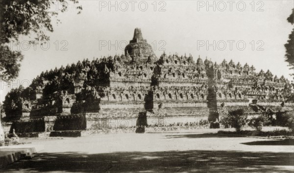 Borobudur, Java. View of Borobudur, a ninth century Buddhist monument that comprises nine tiered platforms decorated with relief panels and 72 stupas containing statues of the Buddha. Java, Indonesia, July 1940., Java, Indonesia, South East Asia, Asia.