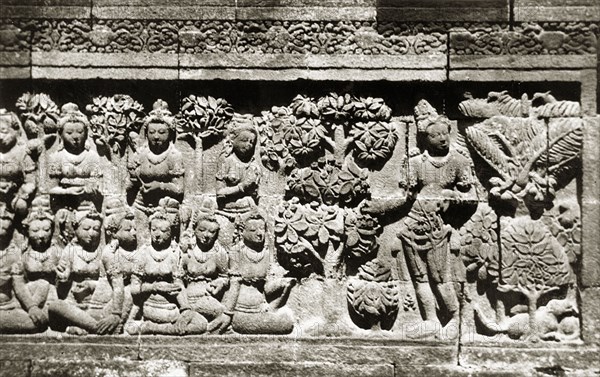 Relief panels at Borobudur . One of many relief panels at the ninth century Buddhist monument of Borobudur. Borobudur contains 1,460 narrative panels depicting Buddhist stories and beliefs, and 1,212 decorative panels. Java, Indonesia, July 1940., Java, Indonesia, South East Asia, Asia.