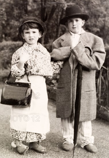 Two brothers dressed up as their parents. Two young brothers, Clive (right) and Tim, dress up in their parents' clothes in the garden of their family home. Sevenoaks, Kent, England, 1950. Sevenoaks, Kent, England (United Kingdom), Western Europe, Europe .