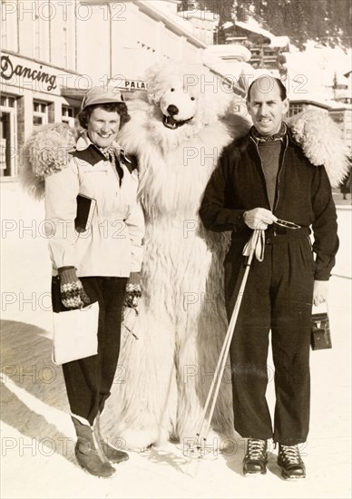 Posing with a polar bear, Switzerland. James and Eileen Murray pose with a performer in polar bear costume during a skiing holiday in Switzerland. Davos, Switzerland, 1951. Davos, Switzerland, Switzerland, Central Europe, Europe .