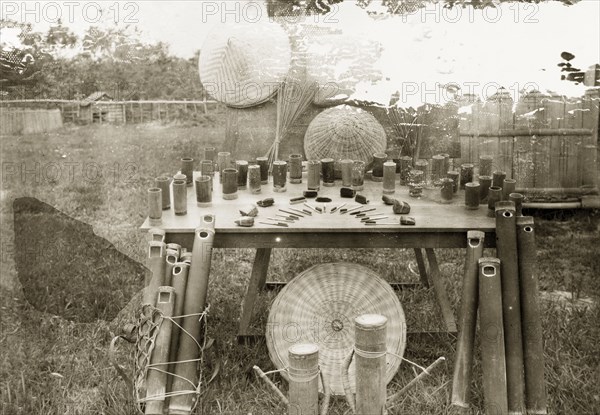 Samples of health products, North Borneo. A display of hygiene aids made by trainee health officers at Keningau Health Centre. Arranged on the display table are bamboo water containers and cups, and toothbrushes and nail brushes made of coconut husks. Keningau, North Borneo (Sabah, Malaysia), circa 1937. Keningau, Sabah (North Borneo), Malaysia, South East Asia, Asia.