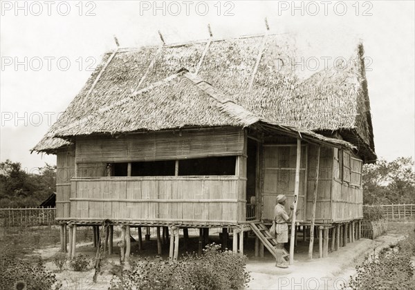 New house, North Borneo. A stilted, bamboo house with a thatched roof, an example of the new housing being built by North Borneo Medical Services as part of a health campaign to introduce new hygiene and sanitation practices to local villages. Keningau, North Borneo (Sabah, Malaysia), circa 1937. Keningau, Sabah (North Borneo), Malaysia, South East Asia, Asia.